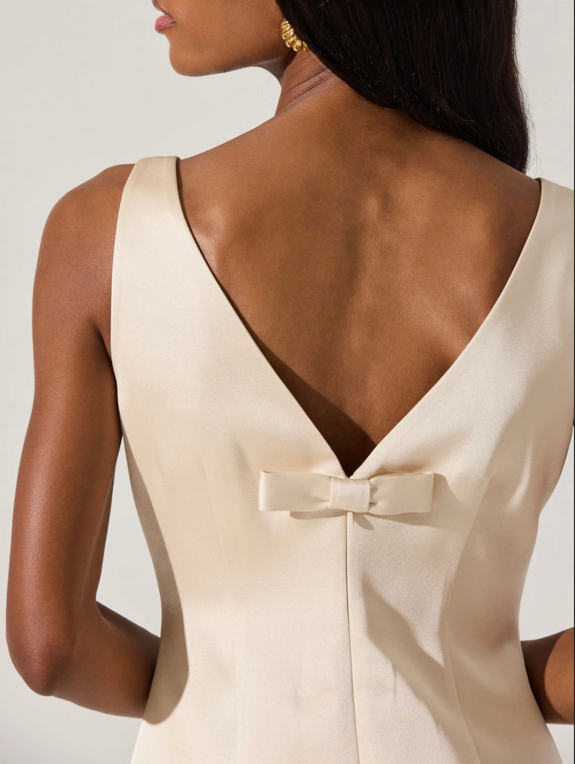 alisanne satin mini dress The Alisanne Dress is oh so darling and classy. This satin mini dress features a high neckline with seam details on the font. The deep v at the back is complemented by